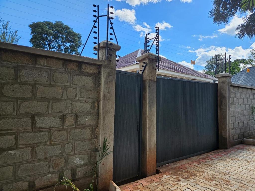 Gated and walled entrance with security fencing